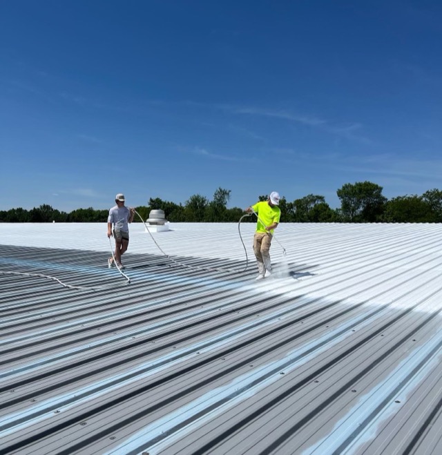 Spraying a white coating over an existing commercial metal roof
